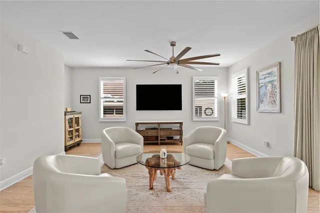 a kitchen with stainless steel appliances granite countertop a stove top oven a sink dishwasher a dining table and chairs with wooden floor