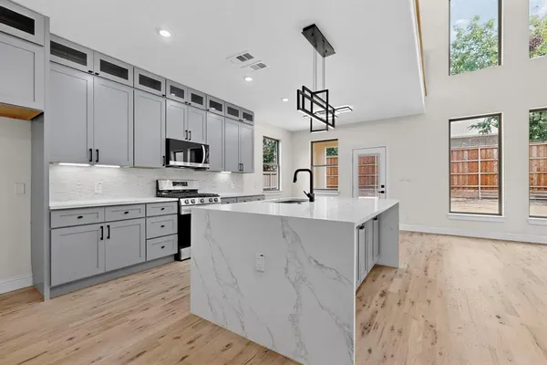 a view of kitchen with microwave and cabinets