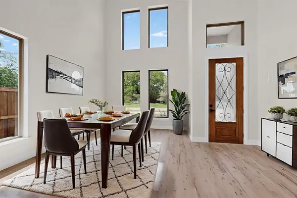 a view of a dining room with furniture window and wooden floor