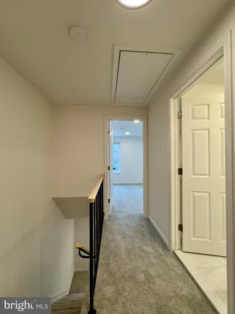 a view of a hallway with furniture