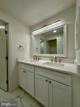 a bathroom with a double vanity sink and mirror