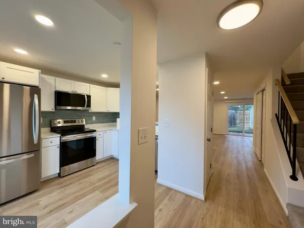 a kitchen with a refrigerator a stove top oven a sink and dishwasher