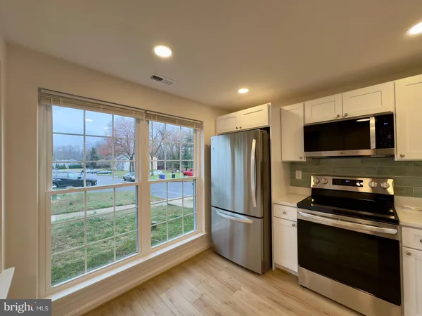 a kitchen with stainless steel appliances a refrigerator microwave and stove