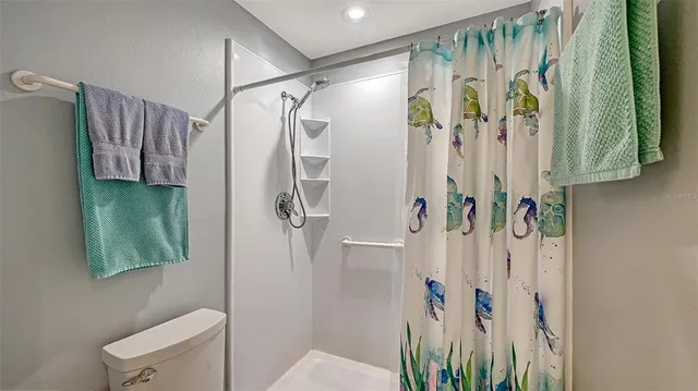 a bathroom with a shower curtain and a shower curtain