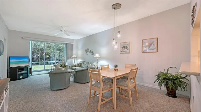 a dining room with a large window and table