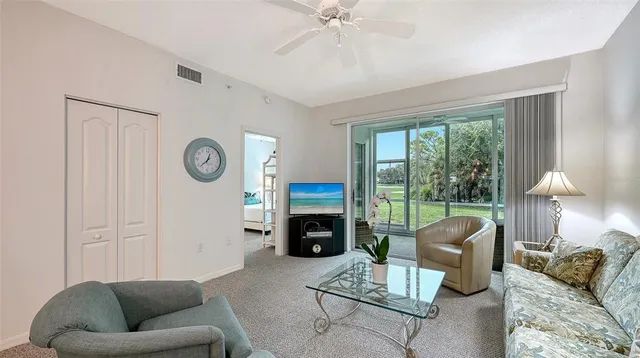 a living room with furniture a large window and a fireplace