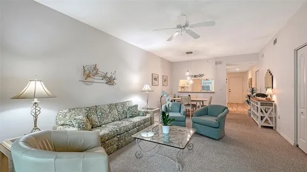 a living room with furniture and a lamp
