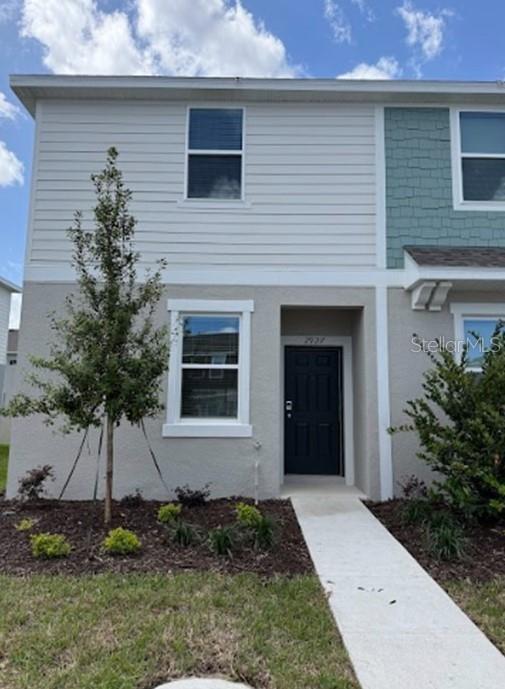 a front view of a house with a yard
