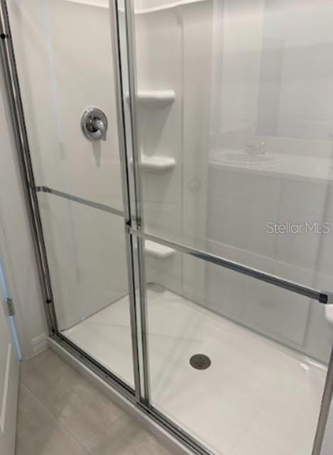 2927 Skyline Loop Kissimmee, FL 34758 - Photo 12 of 17 a bathroom with a glass shower door