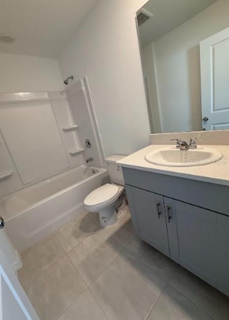 2927 Skyline Loop Kissimmee, FL 34758 - Photo 16 of 17 a bathroom with a double vanity sink a toilet and a mirror