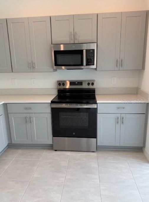 2927 Skyline Loop Kissimmee, FL 34758 - Photo 4 of 17 a kitchen with stainless steel appliances granite countertop a stove top oven and cabinets