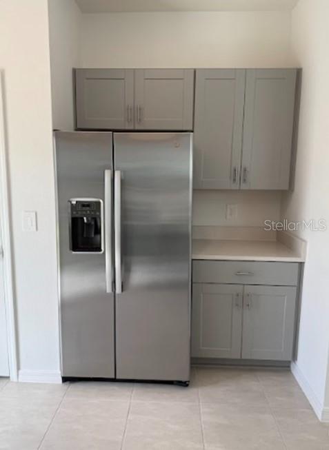 2927 Skyline Loop Kissimmee, FL 34758 - Photo 6 of 17 a kitchen with cabinets and a refrigerator