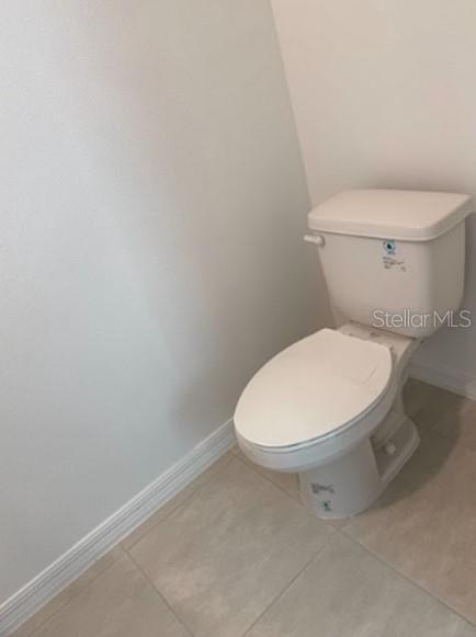 2927 Skyline Loop Kissimmee, FL 34758 - Photo 8 of 17 a white toilet sitting next to a white wall
