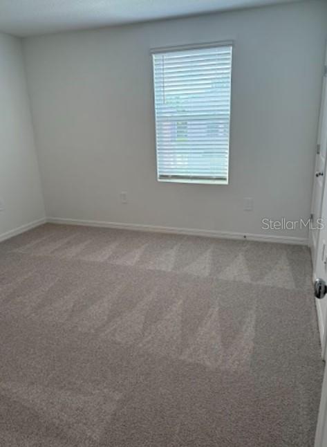 2927 Skyline Loop Kissimmee, FL 34758 - Photo 9 of 17 an empty room with a window