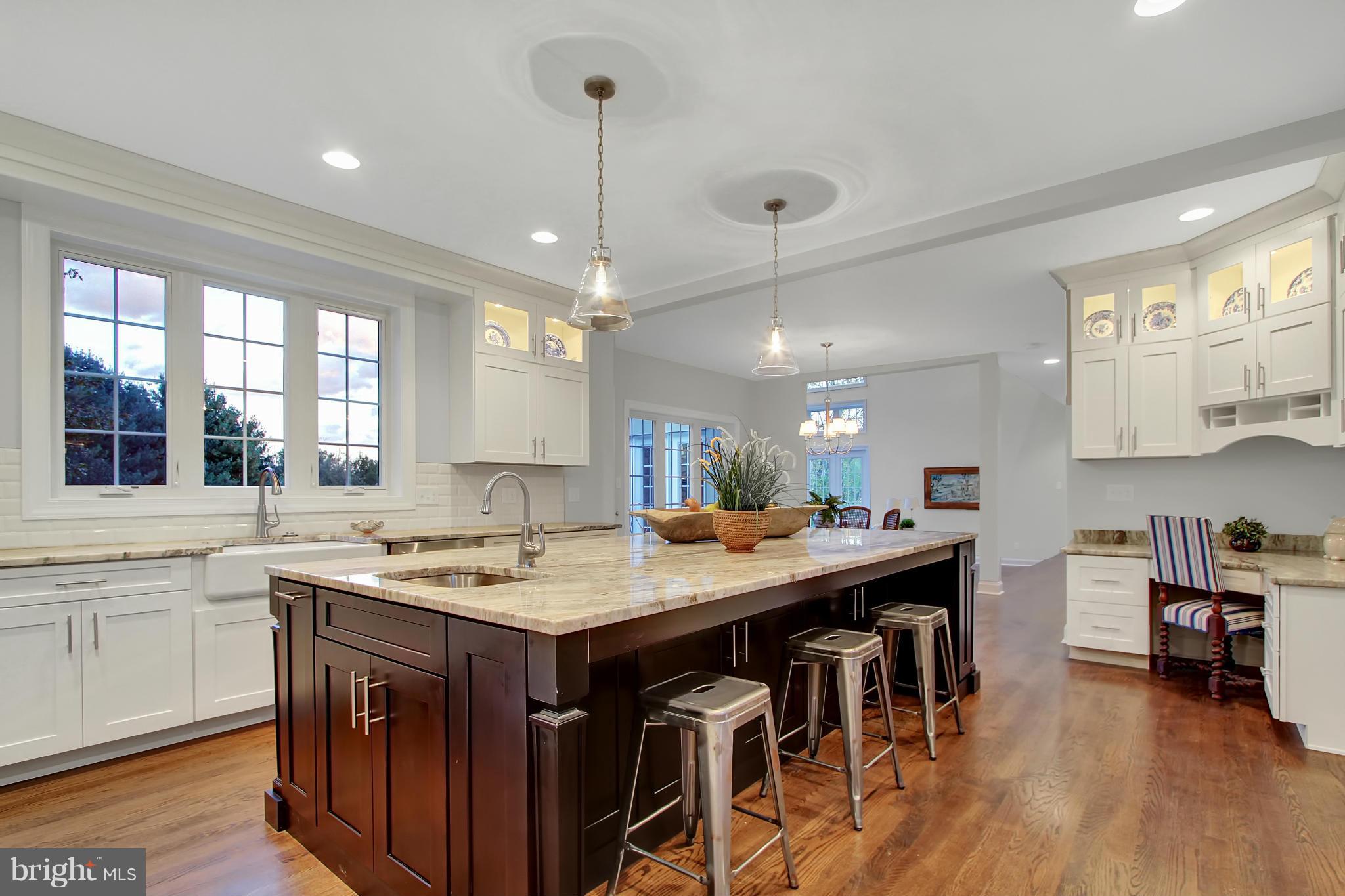 1904 Broadway Road Lutherville-Timonium, MD 21093 - Photo 2 of 30 a kitchen with a stove a sink a dining table and chairs