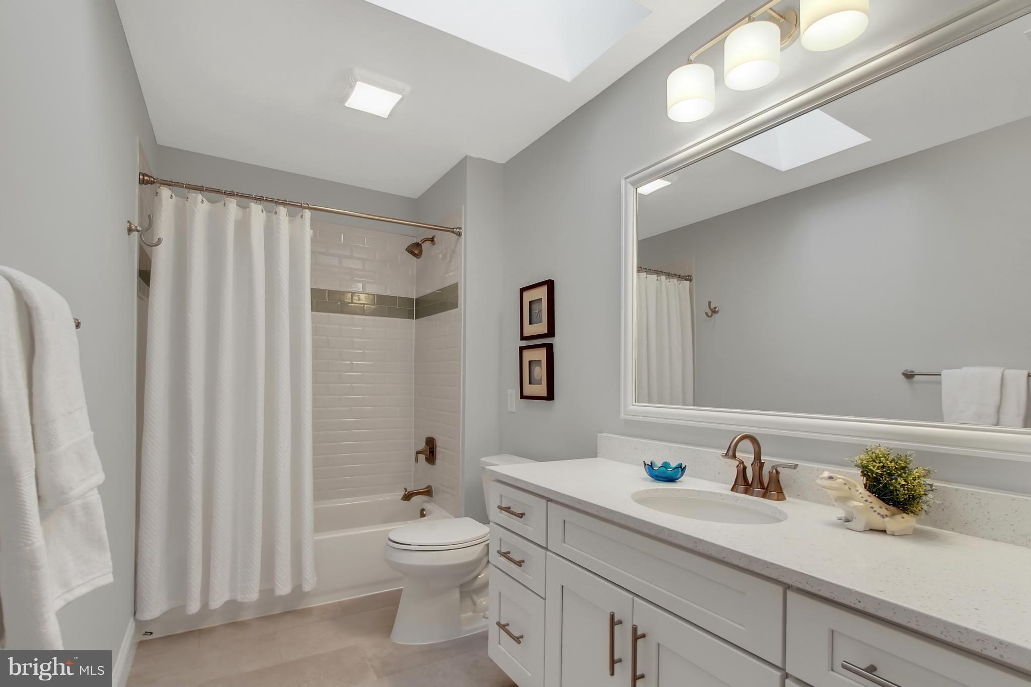 1904 Broadway Road Lutherville-Timonium, MD 21093 - Photo 22 of 30 a bathroom with a granite countertop sink a toilet and a shower