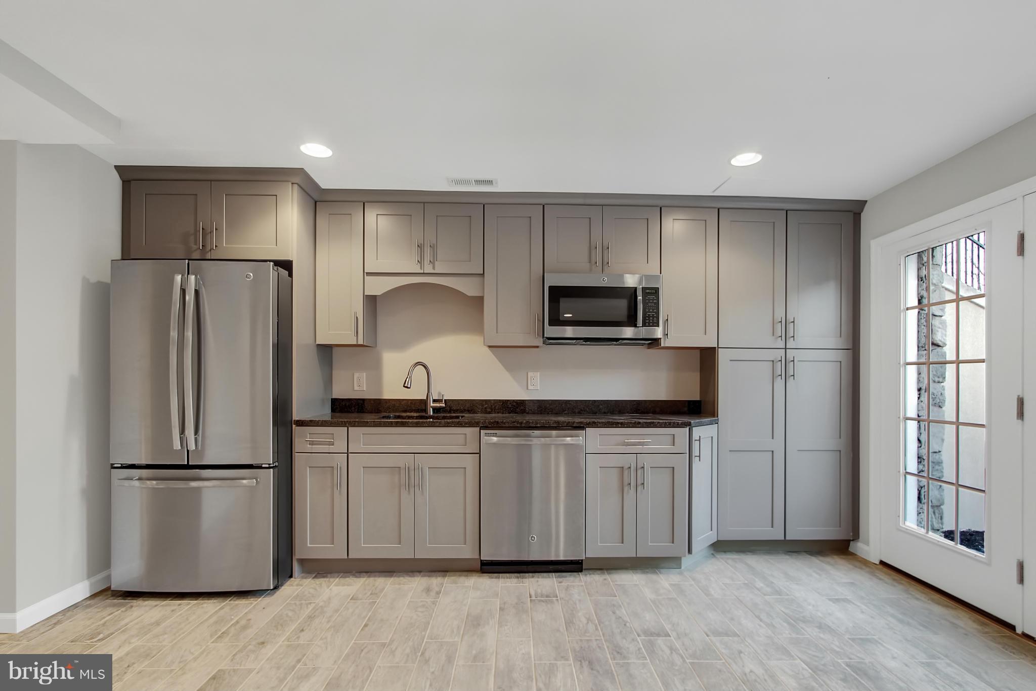 1904 Broadway Road Lutherville-Timonium, MD 21093 - Photo 25 of 30 a kitchen with stainless steel appliances granite countertop a refrigerator a stove a sink and a granite counter tops