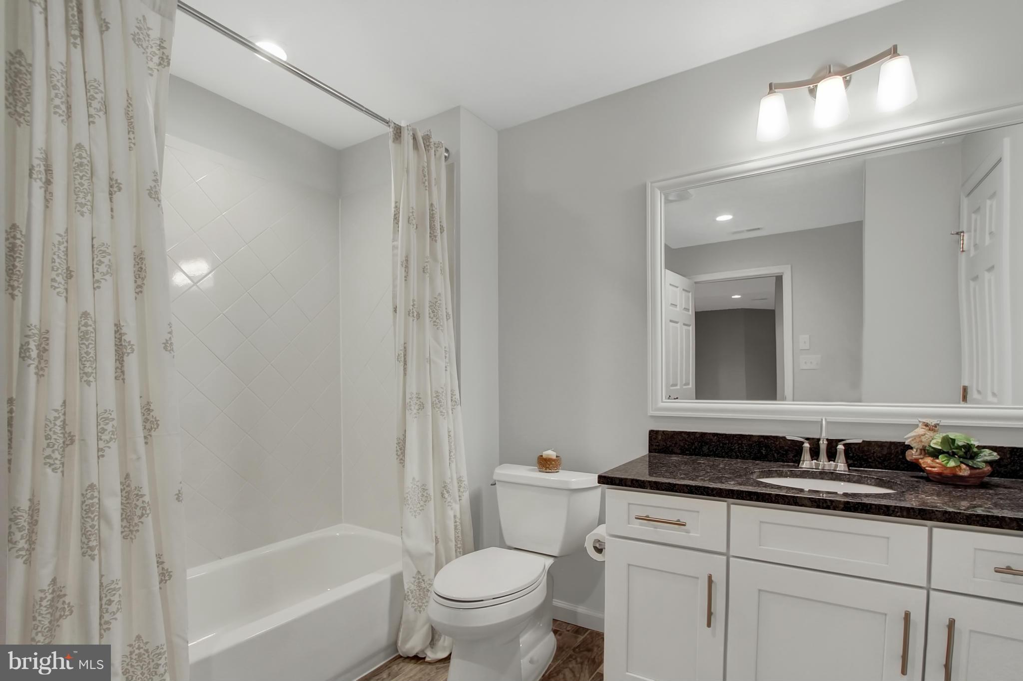 1904 Broadway Road Lutherville-Timonium, MD 21093 - Photo 26 of 30 a bathroom with a granite countertop sink a toilet and a bathtub