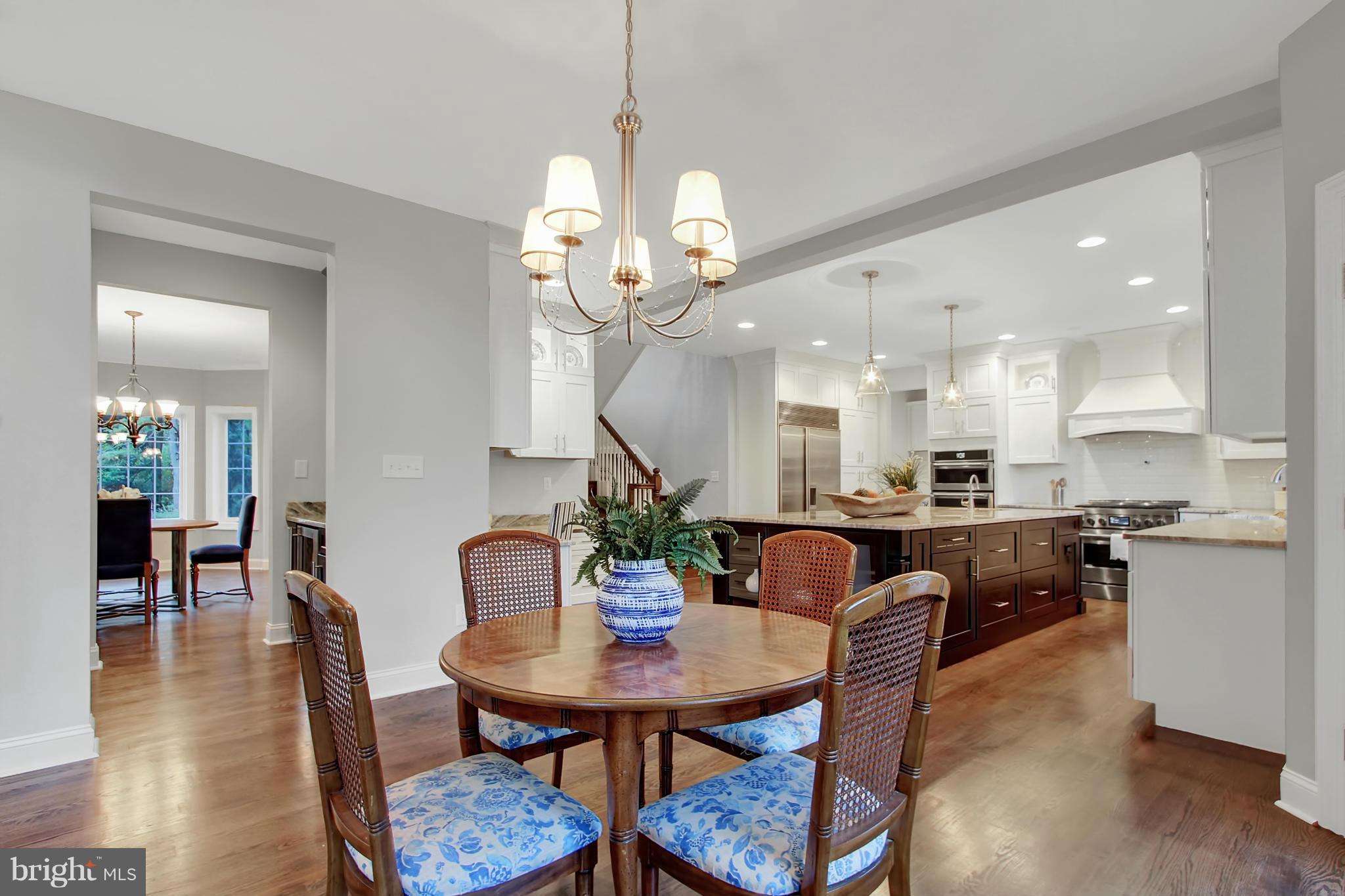 1904 Broadway Road Lutherville-Timonium, MD 21093 - Photo 10 of 30 a view of a dining room and livingroom with furniture wooden floor a chandelier