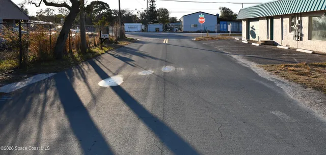 a view of a street with cars parked on the road