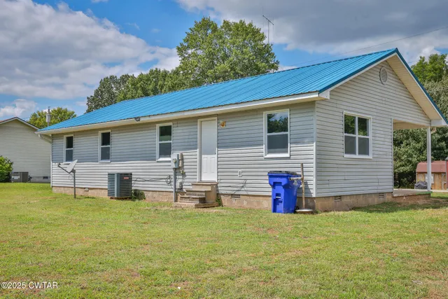 a front view of house with yard and slide