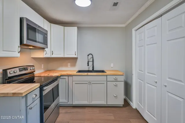 a kitchen with a sink stove and microwave
