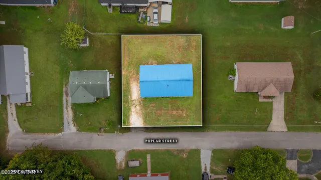an aerial view of a house with a yard