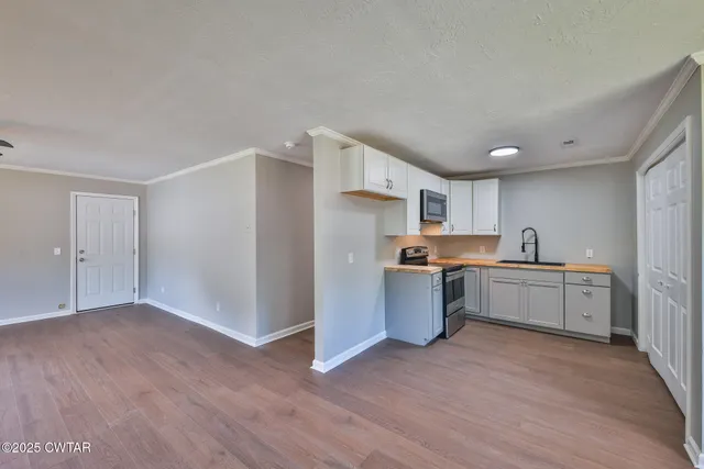 a kitchen with a refrigerator and a sink