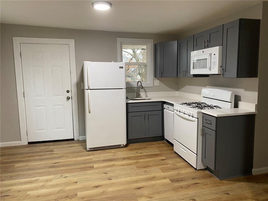 951 Tilden Street Northwest, Unit A Atlanta, GA 30318 - Photo 6 of 6 a kitchen with a sink stove and refrigerator