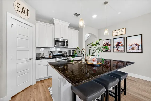 a kitchen with granite countertop stainless steel appliances lots of counter top space