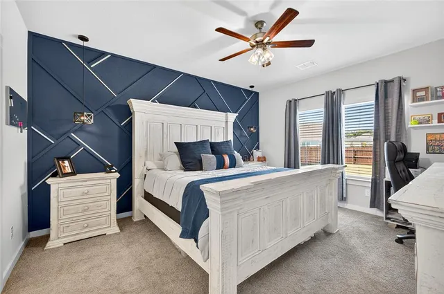 a bed sitting in a bedroom next to a window