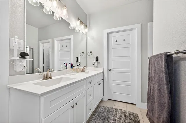 a bathroom with a sink vanity and a mirror