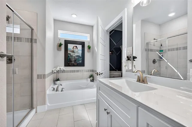 a bathroom with a tub sink and mirror