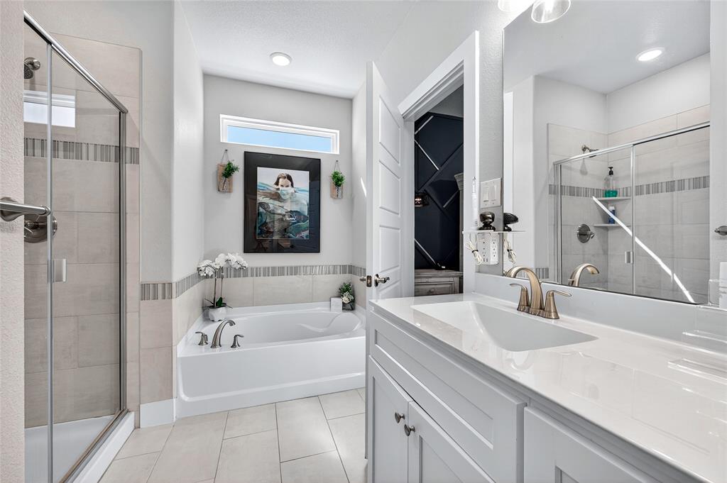 608 Finlee Way Tioga, TX 76271 - Photo 17 of 35 a bathroom with a tub sink and mirror