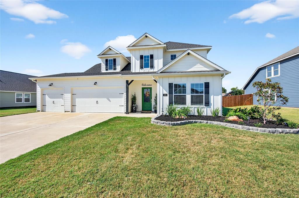 608 Finlee Way Tioga, TX 76271 - Photo 2 of 35 a front view of a house with a yard and garage