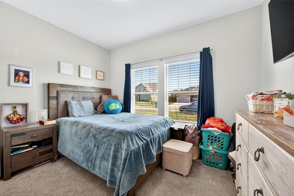 608 Finlee Way Tioga, TX 76271 - Photo 23 of 35 a bedroom with a bed and a table chair