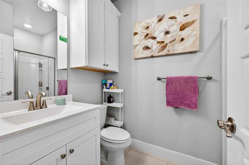 608 Finlee Way Tioga, TX 76271 - Photo 24 of 35 a bathroom with a sink vanity mirror and toilet