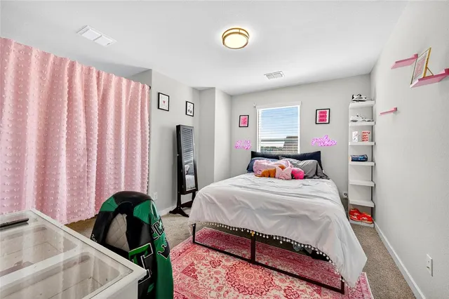 a bedroom with a bed and a potted plant