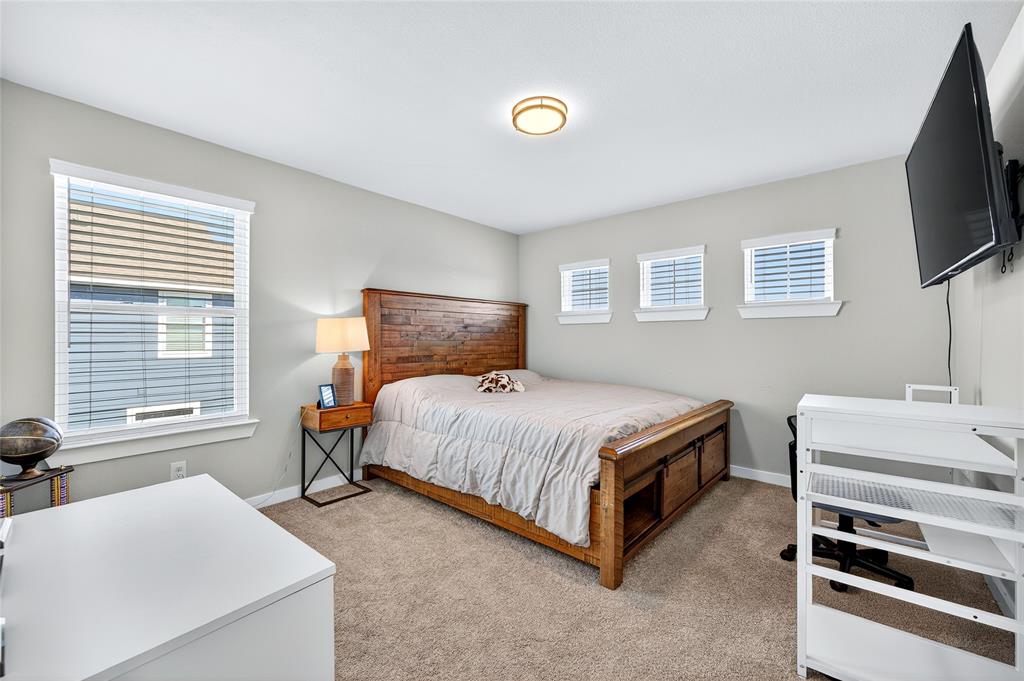 608 Finlee Way Tioga, TX 76271 - Photo 29 of 35 a bedroom with a bed and a flat screen tv