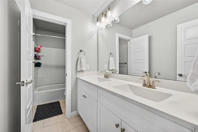 a bathroom with a sink double vanity and a mirror