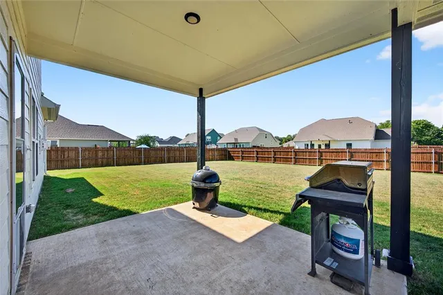a house view with a garden and outdoor seating space
