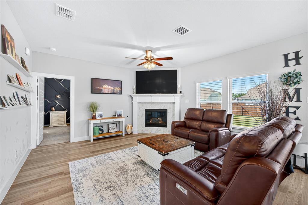 608 Finlee Way Tioga, TX 76271 - Photo 7 of 35 a living room with furniture a flat screen tv and a fireplace