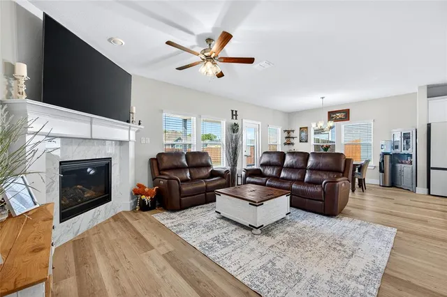 a living room with furniture a fireplace and a flat screen tv