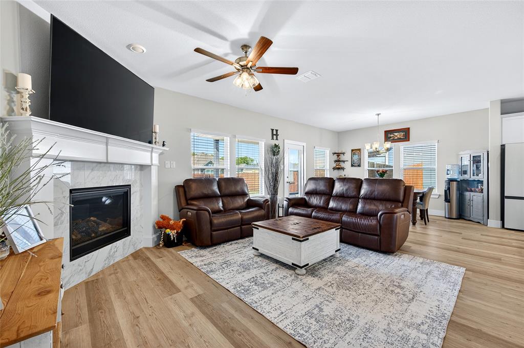 608 Finlee Way Tioga, TX 76271 - Photo 8 of 35 a living room with furniture a fireplace and a flat screen tv