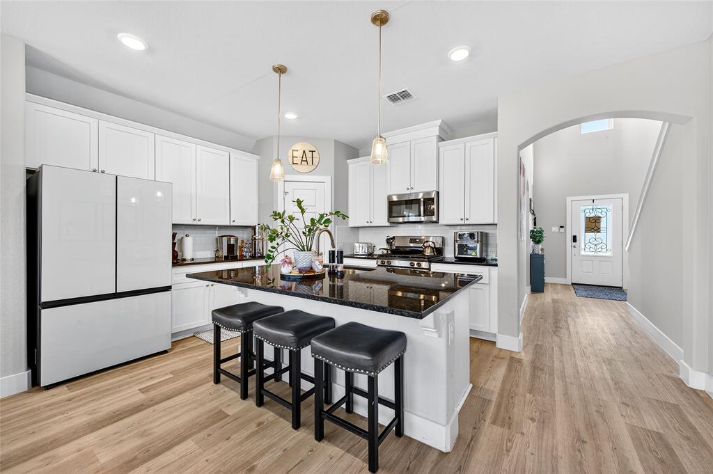 608 Finlee Way Tioga, TX 76271 - Photo 9 of 35 a kitchen with stainless steel appliances a stove a sink a refrigerator and a oven