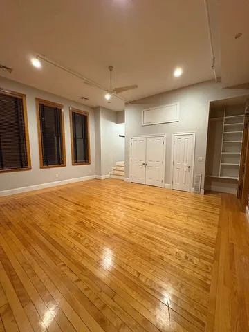 a view of an empty room with closet area