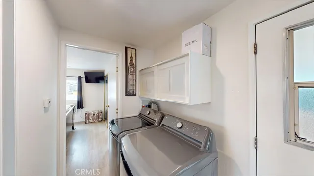 a view of living room with furniture and wooden floor
