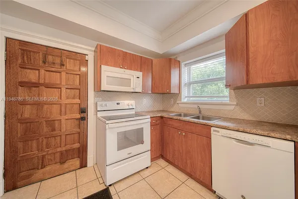 a kitchen with stainless steel appliances granite countertop a sink and a stove