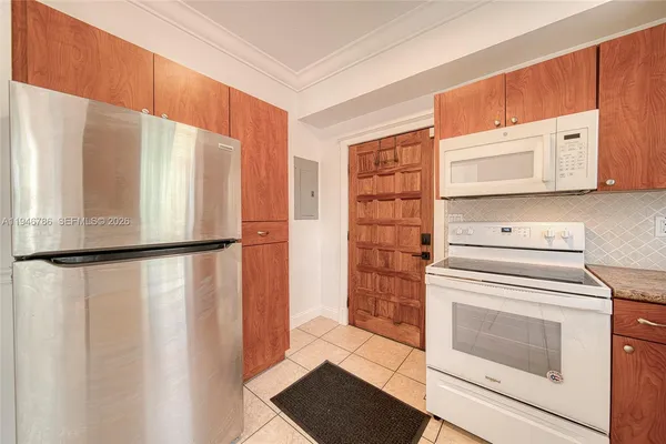 a kitchen with a refrigerator a stove and cabinets