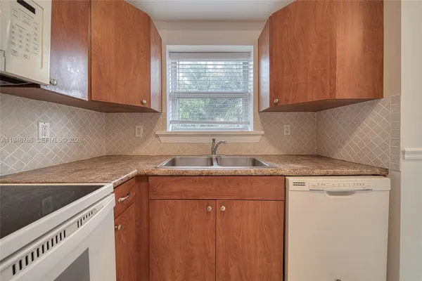 a kitchen with a sink cabinets and window
